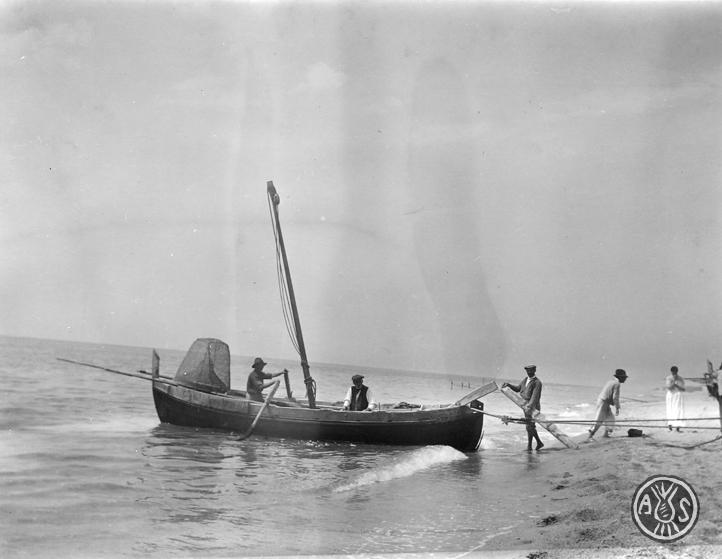 Arribada d'una barca a una platja de Caldes d'Estrac
