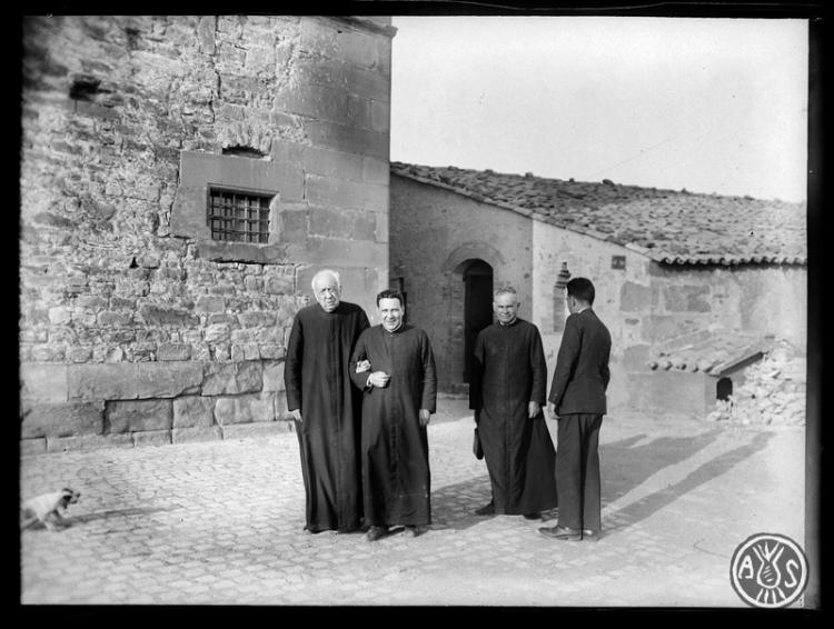 El canonge Jaume Collell i Bancells del braç de Lluís Carreras, al costat mossèn Antoni Baranguer i d'esquenes Miquel Carreras (?). Vic