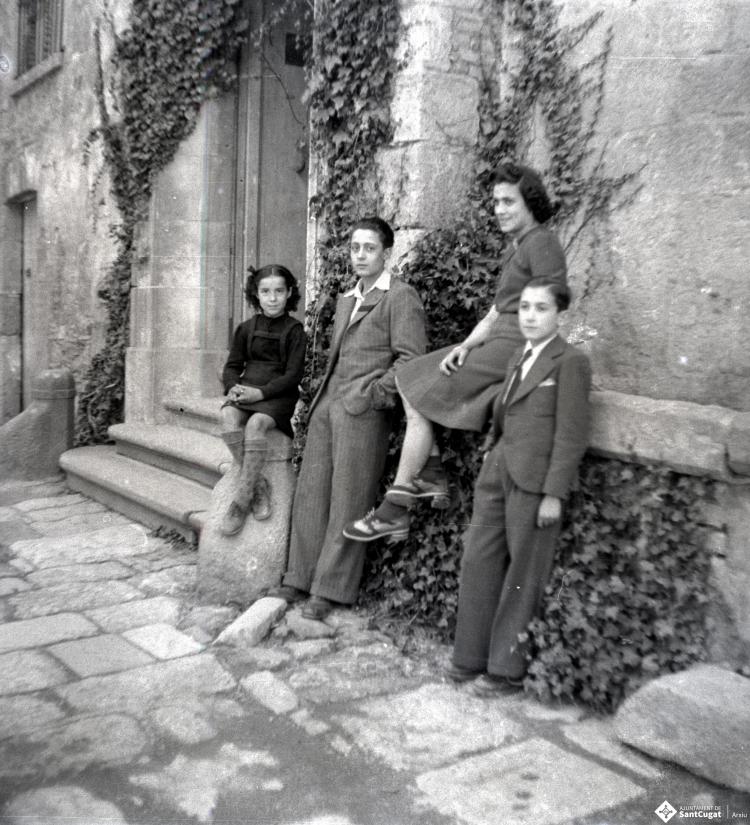 Joves retratats davant el palau abacial i el claustró.