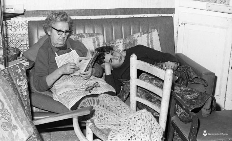 Dona gran llegint amb jove ajagut
