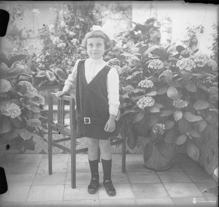 Retrat d'una nena en un jardí particular