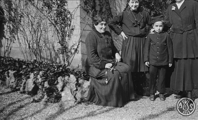 Dones amb un nen amb uniforme militar