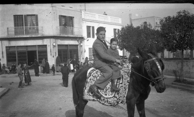 Festa de Sant Antoni Abat. Retrat de dos joves dalt d'un ruc a la plaça de Lluís Millet.