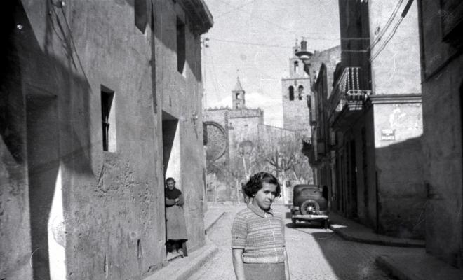 Retrat d'una noia, dempeus, al mig del carrer de Santiago Rusiñol.