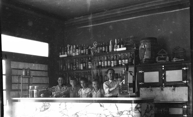 El Camilo Belda amb la seva esposa i el seu fill Jaume, acompanyats de dos infants, a la barra del  Bar Catalunya, de la plaça de Lluís Millet.