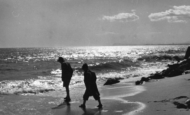 Dos nens caminant per la platja del Masnou