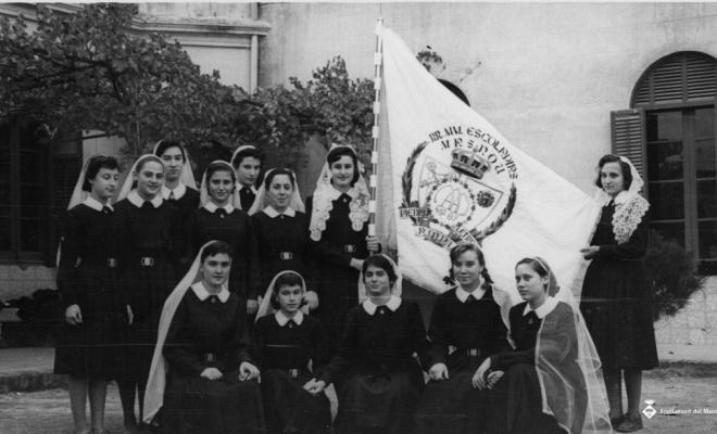 Alumnes de les Escolàpies amb una bandera el dia de Corpus