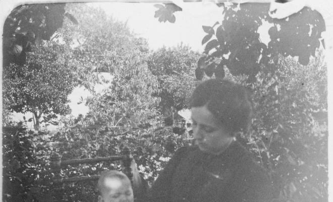 Retrat d'una dona amb un nadó en un jardí