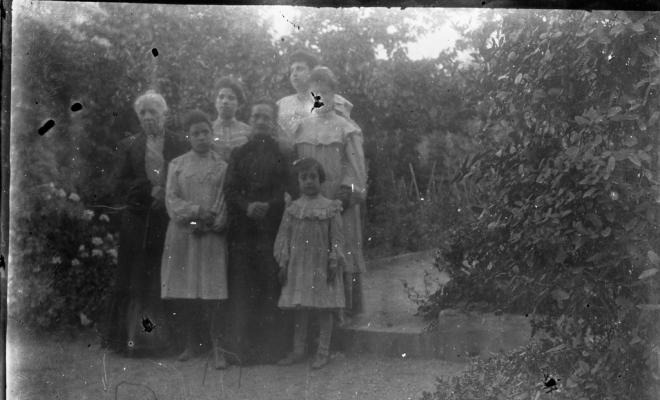 Retrat d'un grup de dones i nenes en un jardí