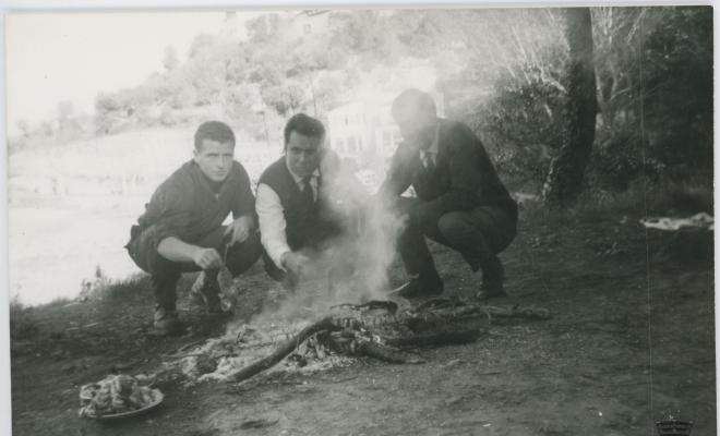 Grup d'amics d'excursió, amb una foguera per fer carn a la brasa