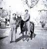 Tres Tombs, retrat de dos nois, un d'ells muntant un ruc, a la plaça d'Octavià.