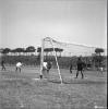 Activitats festives, partit de futbol. Ubicació no identificada, a prop hi ha una catenària d'un tren.