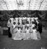 Festa Major. Ball a l'envelat, retrat d'un grup de nenes, probablement de la secció infantil de l'Esbart Dansaire, acompanyades per  Manuel Farrés i dues dones uniformades.