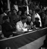 Festa Major. Autoritats assegudes darrere una taula amb copes i trofeus, presideixen l'acte, el governador civil i Antonio Federico Correa Véglison, mossèn Griera,  i Nicolau Villar Recio.
