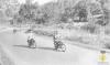 Grup de jove en bicicleta i motocicleta per l'actual carretera BV-2421 el dia de la visita del bisbe de Barcelona